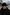 Herren-Cap aus Lammfell in Schwarz, seitlich getragen im Winterlook.