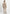 Rückansicht der beige Curly-Lammfelljacke für Damen mit geradem Schnitt.