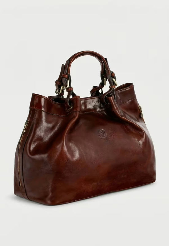 Braune Leder-Handtasche in Seitenansicht mit zwei Henkeln und sichtbarem Reißverschluss.