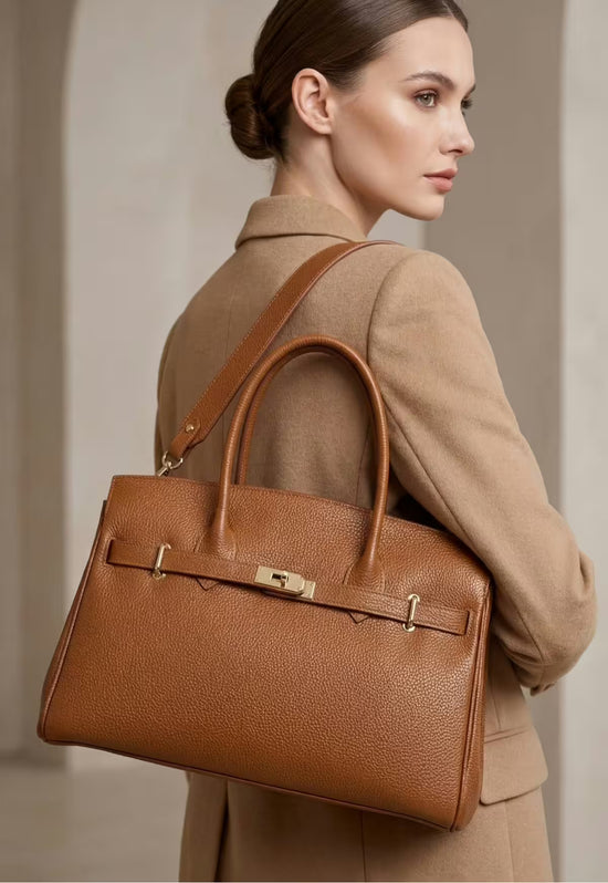 Kamelbraune Lederhandtasche für Damen als Trageansicht über der Schulter.