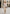 Creme-beige Lammfelljacke für Damen im Citylook, vorne getragen mit Midi-Kleid und Handtasche.