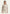Creme-beige Lammfelljacke für Damen an einem Model, vorne getragen mit breitem Revers und langen Ärmeln.