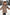 Kind in beige Lammfelljacke mit Kapuze und Fellbesatz, seitlich im Schnee unterwegs